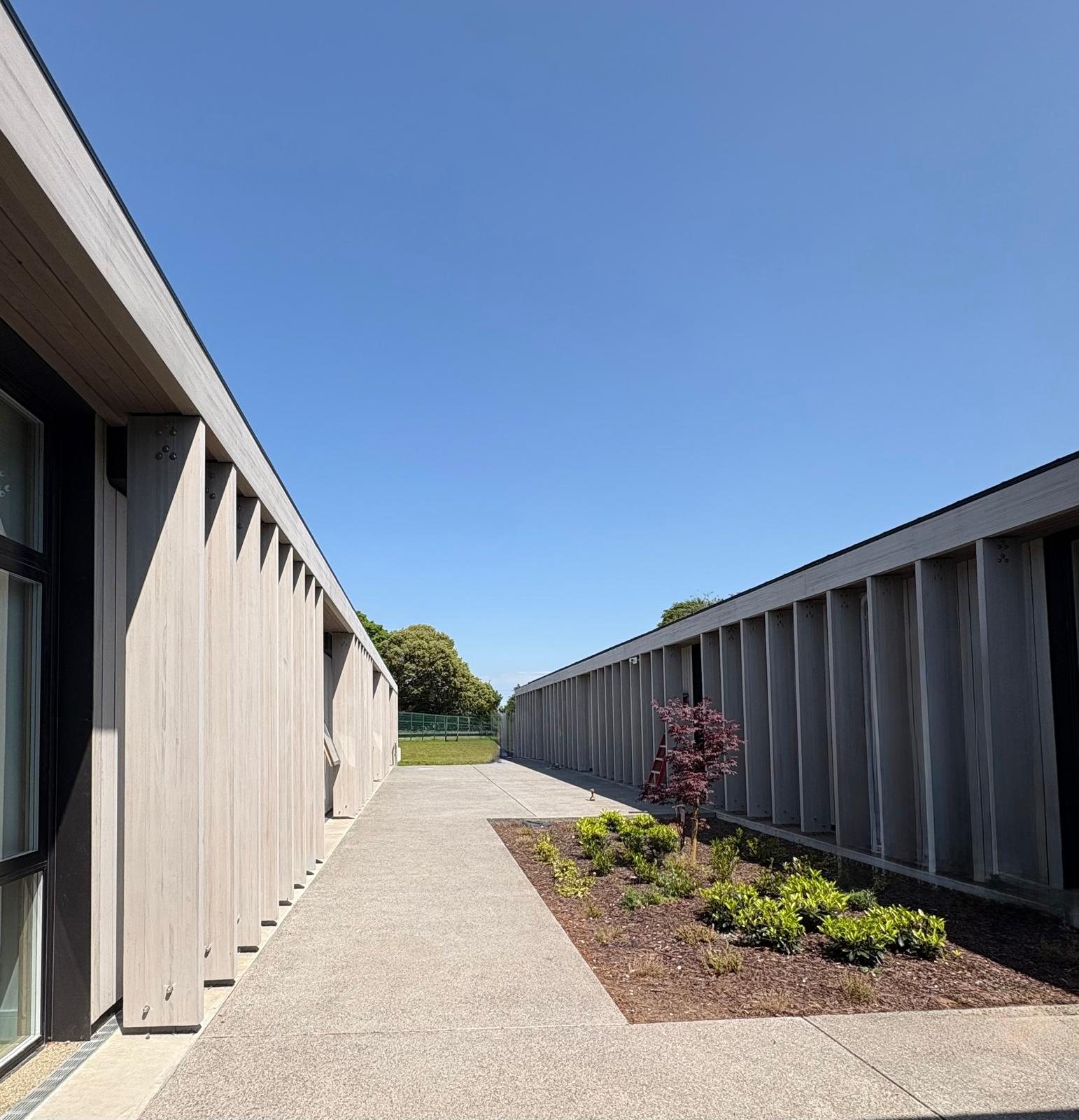 Timber-clad façade with vertical fins, St Flannan's College