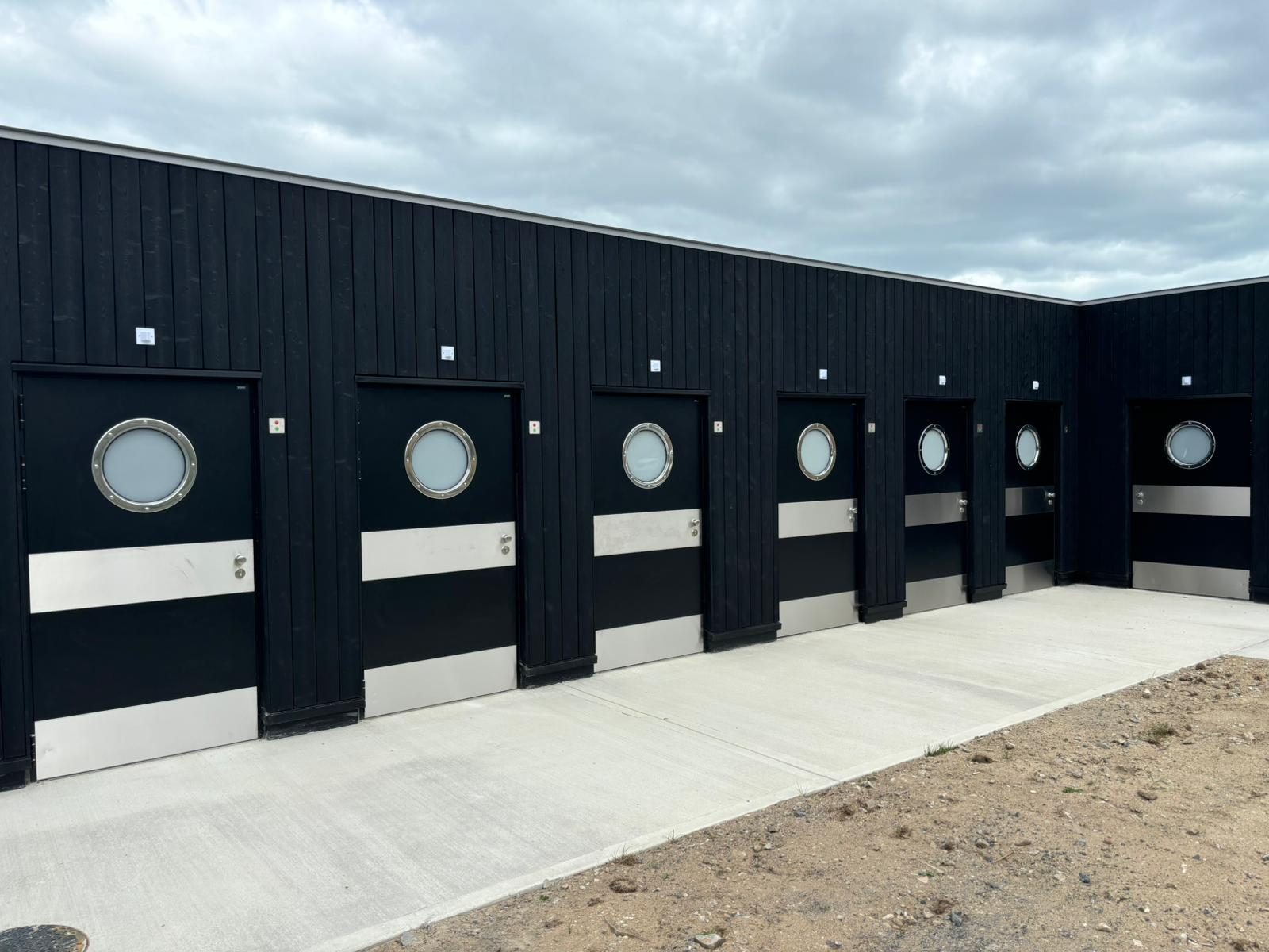 Public amenity building with porthole doors